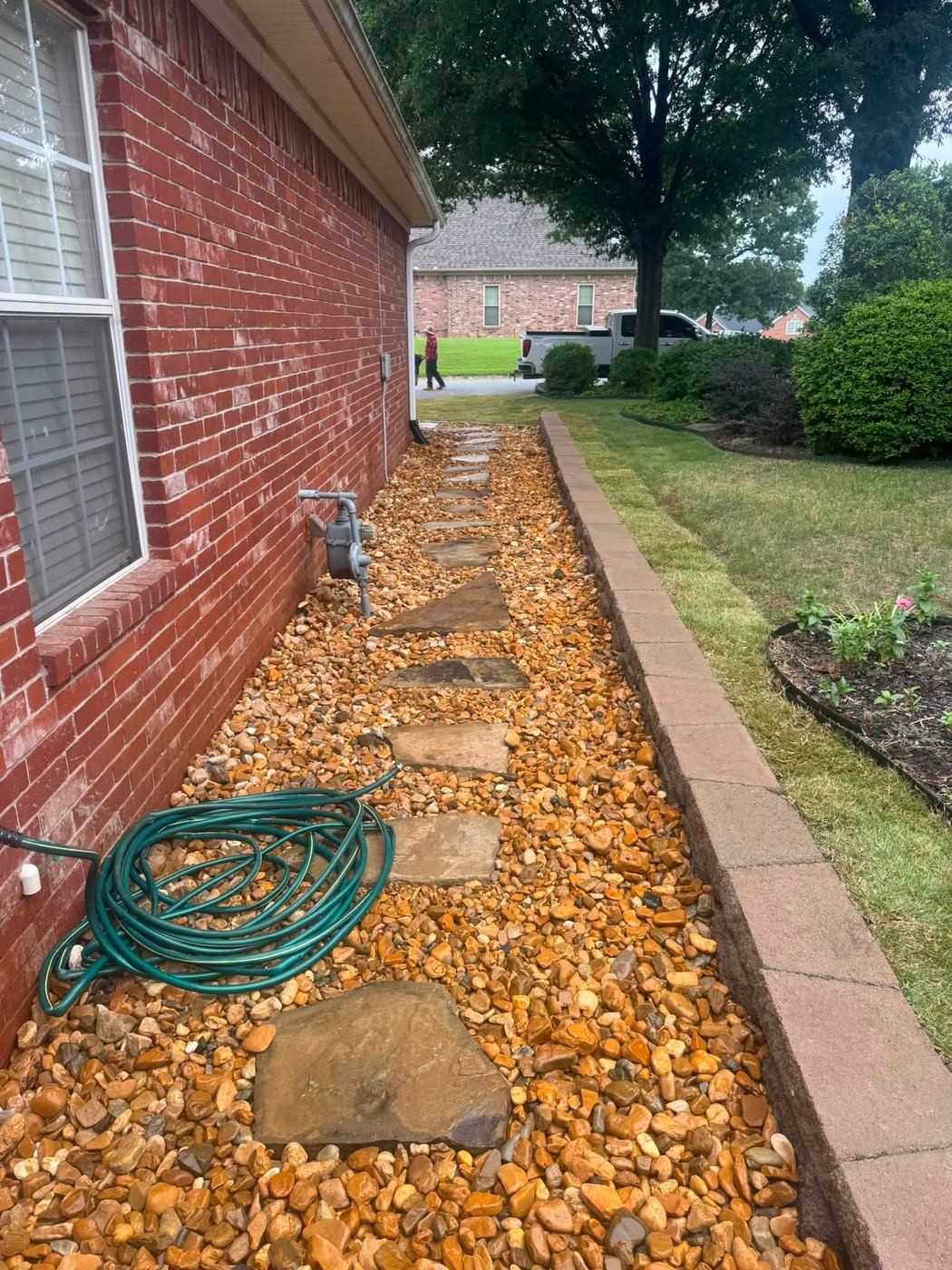 The same area finished with river rock and flagstone stepping stones